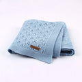 Couverture bébé en coton tricoté bleue pliée